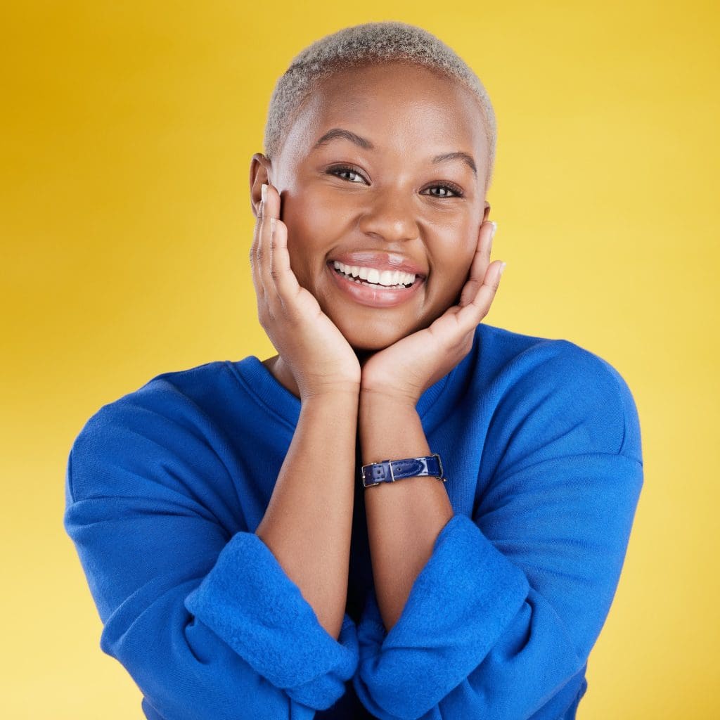 Smile, hands on face and portrait of black woman in studio with happy, positive mindset and confide